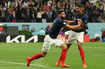Olivier Giroud celebrates with Raphael Varane after scoring France's winner against England