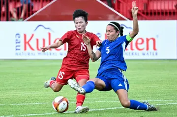 Nguyen Thi Bich Thuy (left) and Philippines' captain Hali Long, who both scored for their respective sides