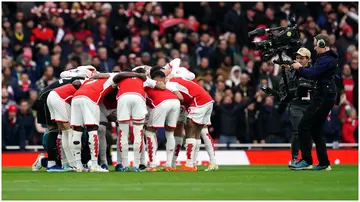 Arsenal players in a group huddle before the Premier League match at the Emirates Stadium. Photo by Nick Potts.
