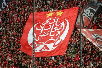 Ultras at the Casablanca stadium hold aloft a giant Wydad flag