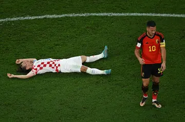Croatia midfielder Luka Modric (L) and Belgium forward Eden Hazard react after their 0-0 draw