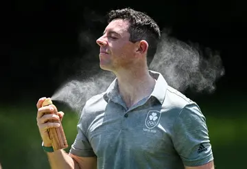 Rory McIlroy of Ireland applies sunscreen spray