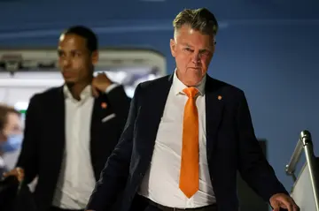 Netherlands coach Louis Van Gaal (R) and defender Virgil van Dijk arriving in Doha on Tuesday