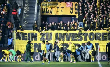 Dortmund fans unveil a banner opposing investment in German football at an away match against Bayer Leverkusen on Saturday