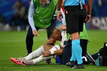 Kylian Mbappe receives medical treatment after breaking his nose during France's 1-0 win against Austria at Euro 2024