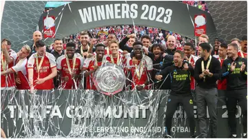 Arsenal players celebrate with the Community Shield trophy after their match against Manchester City at Wembley Stadium. Photo by Rob Newell.