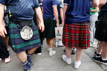 Supporters of Scotland's national soccer team carry beer crates ahead of the Euros opener