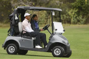 Tiger Woods rides in a golf cart with daughter Sam Woods