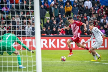 Olympiacos midfielder Antonios Papakanellos shapes to score the second goal