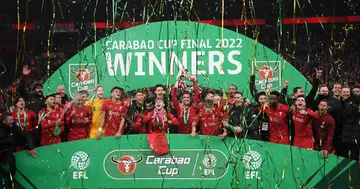 Jordan Henderson of Liverpool lifts the Carabao Cup trophy following victory in the Carabao Cup Final match between Chelsea and Liverpool at Wembley Stadium on February 27, 2022 in London, England. (Photo by Shaun Botterill/Getty Images)