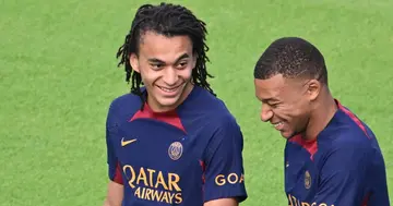 Ethan Mbappe sharing a joke with brother Kylian.