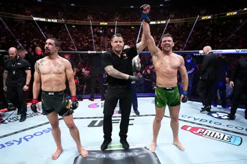 Dricus du Plessis has his hand raised after beating Robert Whittaker.