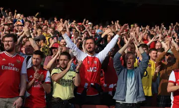 Arsenal fans sing during the Premier League match against Tottenham Hotspur