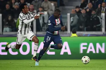 Nuno Mendes (R) holds off Juan Cuadrado to score Paris Saint-Germain's winner against Juventus