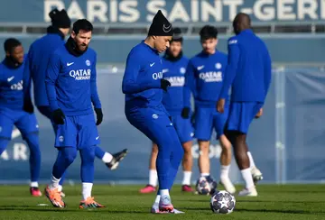 Kylian Mbappe and Lionel Messi (L) in training with their PSG teammates on Monday