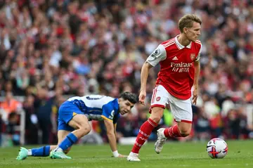Arsenal's Martin Odegaard (R) in action against Brighton