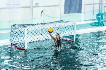 Water polo goalkeeper holding the ball