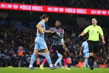 Iheanacho clashes with Ruben Dias after scoring Leicester's third goal during the Premier League match between Manchester City and Leicester City at Etihad Stadium