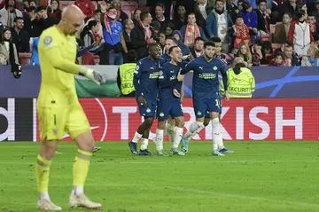 Ricardo Pepi (2R) celebrates scoring PSV's third goal which eliminated Sevilla