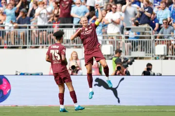 Manchester City forward Erling Haaland, right, celebrates after scoring his second goal against Chelsea in a pre-season English club friendly at Columbus, Ohio