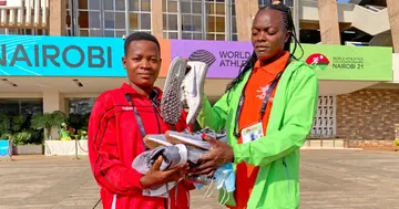 Mary Moraa donates running gear to Burundian athlete Jeanine Keazimana. Photo: Capital FM.