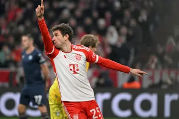 Bayern Munich forward Thomas Mueller points to the sky. He called upon the "football gods" to help his side keep track with Bayer Leverkusen.