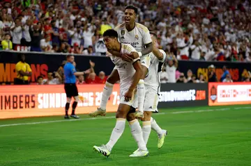 Jude Bellingham (left) is celebrates with team-mate Rodrigo after opening the scoring for Real Madrid against Manchester United