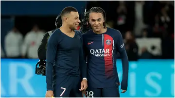 Kylian Mbappe and his brother, Ethan on the field for Paris Saint-Germain on December 20, 2023, in Paris, France.