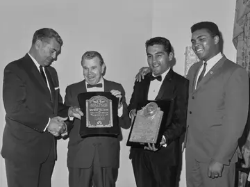 Jack Dempsey and Muhammad Ali congratulate Mickey Walker (second left) and Willie Pastrano on receiving awards at the Boxing Writers' Association dinner