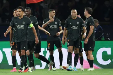 Achraf Hakimi (C) celebrates with teammates after scoring PSG's second goal against Dortmund