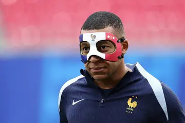 Kylian Mbappe arrives wearing a face mask to take part in a France team training session on Thursday