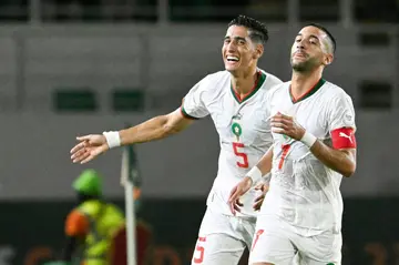 Hakim Ziyech (R) celebrates scoring for Morocco with teammate Nayef Aguerd.