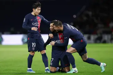 Lee Kang-in (L) comes across to celebrate with Kylian Mbappe after the latter scored PSG's second goal against Toulouse