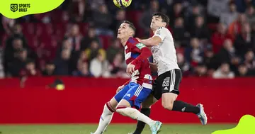 Jose Callejon of Granada CF (l) and Francisco Garcia of Burgos CF (r) battle for the ball