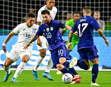 Argentina's Lionel Messi vies for the ball with Honduras' Hector Castellanos in Argentina's 3-0 friendly victory in Florida