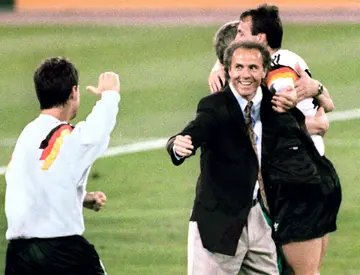 Franz Beckenbauer celebrates with his players after Germany won the 1990 World Cup final in Rome