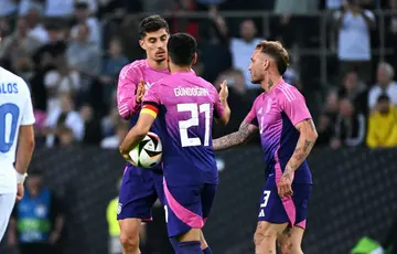 Germany players celebrate the goal that brought them level against Greece