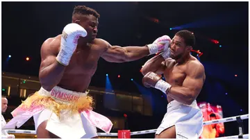 Francis Ngannou punches Anthony Joshua during their Heavyweight fight at the Knockout Chaos boxing card. Photo: Richard Pelham.