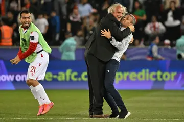 Tajikistan coach Petar Segrt celebrates with his team after beating Lebanon at the Asian Cup