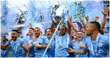 Fernandinho lifts the Premier League trophy after their side finished the season as Premier League champions after victory over Aston Villa at Etihad Stadium. Photo by Michael Regan.