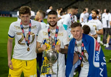 The Leeds United team celebrates becoming champions during the Sky Bet Championship match against Charlton Athletic at Elland Road on July 22, 2020, in Leeds, England.