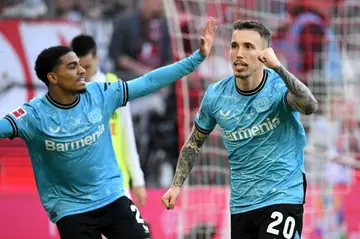 Bayer Leverkusen scorer Alejandro Grimaldo (R) celebrates with Amine Adli
