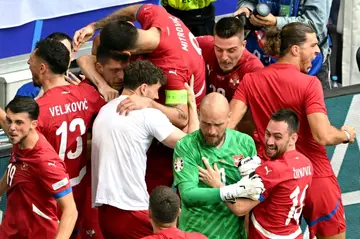 Luka Jovic is mobbed after grabbing a late equaliser for Serbia against Slovenia