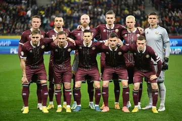 Belarus players line up for a team photo ahead of their Euro 2024 qualifier against Romania last month