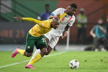 South Africa defender Khuliso Mudau (L) fights for the ball with DR Congo midfielder Aaron Tshibola
