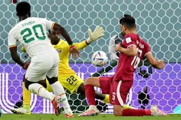 Bamba Dieng (L) sealed Senegal's win and left Qatar on the brink of elmination