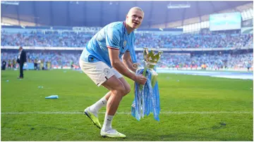 Erling Haaland celebrates with the Premier League trophy following the Premier League match between Manchester City and Chelsea FC at Etihad Stadium. Photo by Tom Flathers.