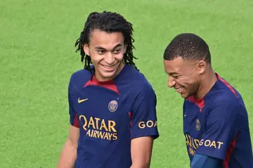 'In a good state of mind': Kylian Mbappe (R) laughs with brother Ethan at the start of Paris Saint-Germain's training session on Friday