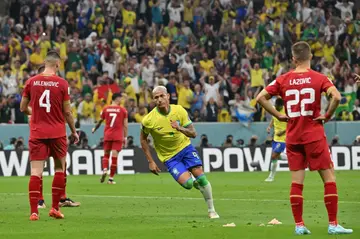 Richarlison runs off in celebration after scoring his and Brazil's second goal against Serbia