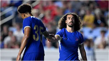 Marc Cucurella high-fives Bashir Humphreys during Chelsea's pre-season match against Wrexham AFC at Kenan Stadium on July 19, 2023, in Chapel Hill, North Carolina.